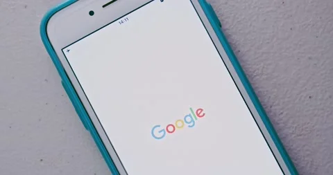 Man touches Google app and an app launches with animation, on iPhone Stock Footage 156942431