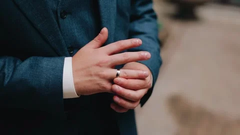 The man touches the ring on his finger. Close-up shooting Stock Footage 302930161