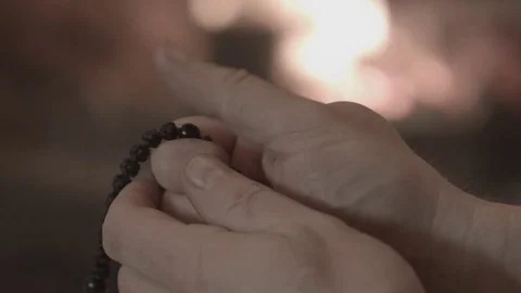 The man touches the rosary Stock Footage 74196653