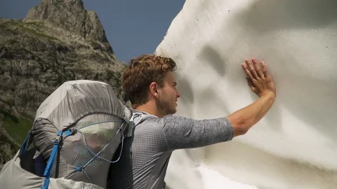 Man touching and examining melting ice cap, slow motion Stock Footage 129610982