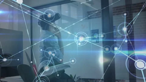 Man touching chin, adjusting VR headset in glass office, HUD growing into node Stock Footage 334179165