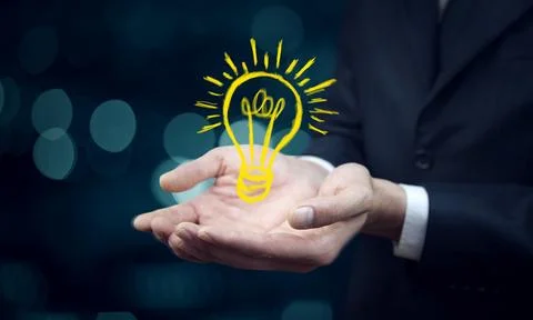 Man touching e light bulb on screen Stock Photos