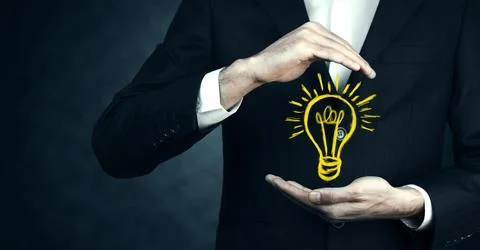 Man touching e light bulb on screen Foto stock