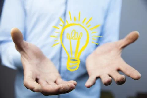 Man touching e light bulb on screen Stock Photos