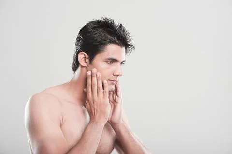 Man touching his face after shaving Fotos Stock