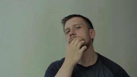 Man touching his moustache and looking at the camera. Video stock 77413641