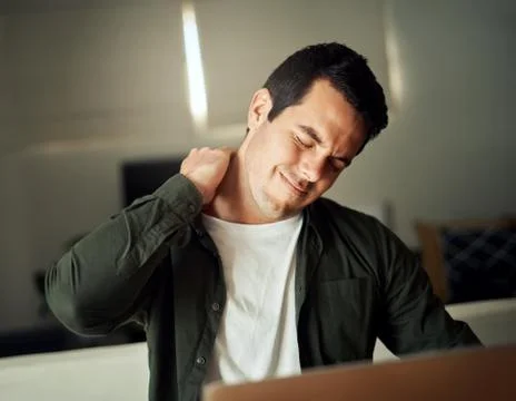 Man touching his neck with hand suffering from pain Stock Photos