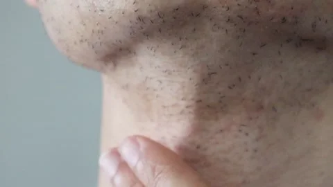 Man touching his skin after shaving Stock Footage 326088058