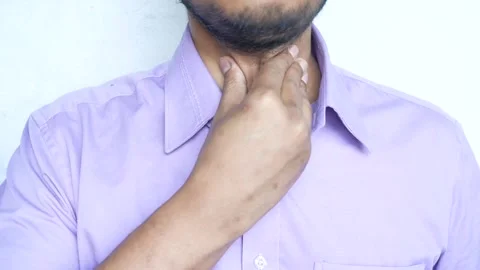 Man touching his throat, checking for sore throat or thyroid issues, health.. Stock Footage 332858760