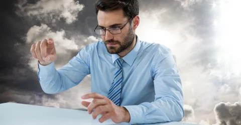 Man touching imaginary object in sky 스톡 사진