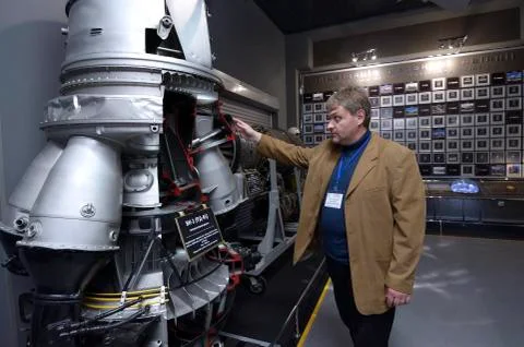 Man touching a jet engine set on a stand Stock Photos