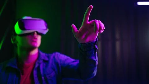 Man touching objects in the 3D environment created by VR goggles Stock Photos