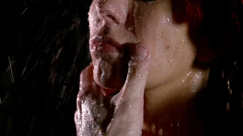 Man is touching passionately lips of girlfriend by thumb, close-up of face Stock Footage 104214129