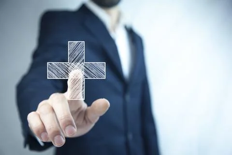 Man touching plus or cross sign in screen Stock Photos