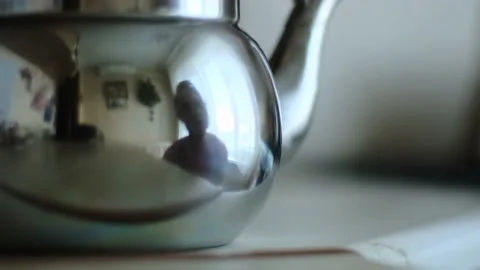 Man touching the polished shiny surface of the teapot with his finger, closeup Stock Footage 195514348