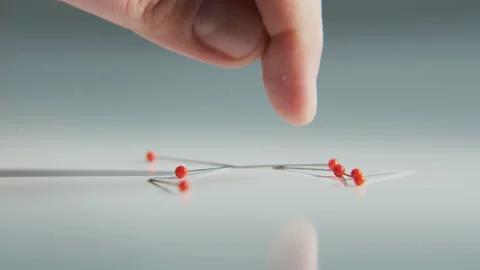 Man Touching Red-Headed Needles With his Finger Stock Footage 90063222