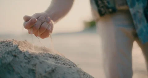 Man Touching Sand At Beach Looking for Inspiration Hard Times Concept Vidéo 246536344