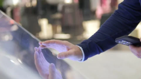 A man is touching a screen with his finger and holding a cell phone Stock Footage 297492289