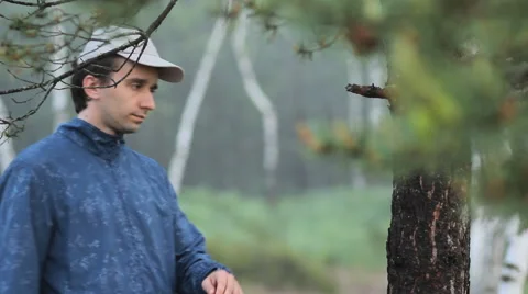 Man touching smart watch near a tree in the forest. Early morning Stock Footage 64597989