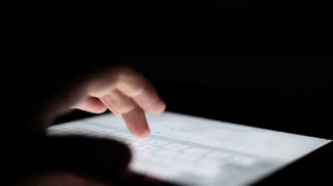 Man touching tablet touch screen at dark Stock Footage 67612494