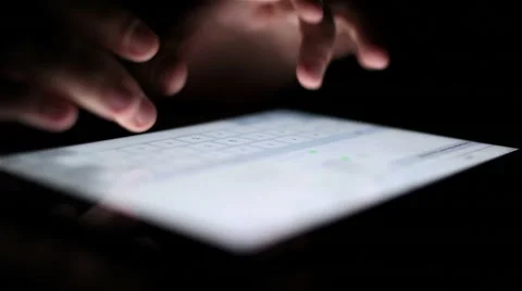 Man touching tablet touch screen at dark Stock Footage 67612497