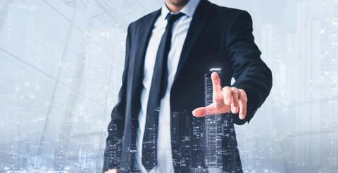 Man touching virtual screen,  modern skyline hologram - real estate business  Stock Photos