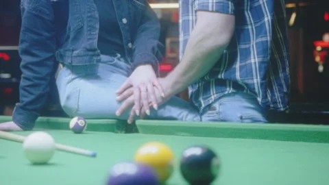 Man touching a woman's leg next to a snooker table indoors Stock Footage 275001175