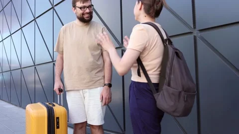 Man tourist asks for directions how to get through from a woman on the street Stock Footage 236557799
