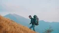 The man with a tourist backpack climbs on a mountain 4k or 4k+ Resolution