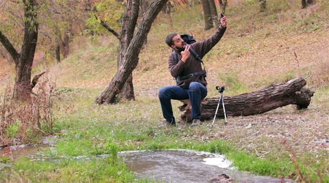 Man tourist with a backpack. Selfie in the forest. Stock Footage 56617895