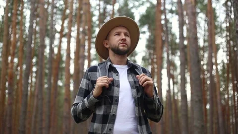 Man tourist with a backpack while hiking in the forest or mountains. Hiking Stock Footage 149946586
