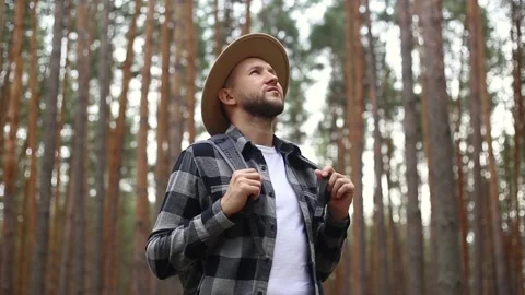 Man tourist with a backpack while hiking in the forest or mountains. Hiking Stock Footage 149946587