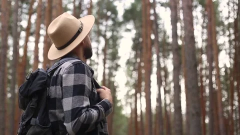 Man tourist with a backpack while hiking in the forest or mountains. Hiking Video stock 149946592