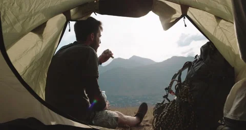 Man is a tourist, backpacker, freelancer is sitting drinking refreshing water Video stock 224304959