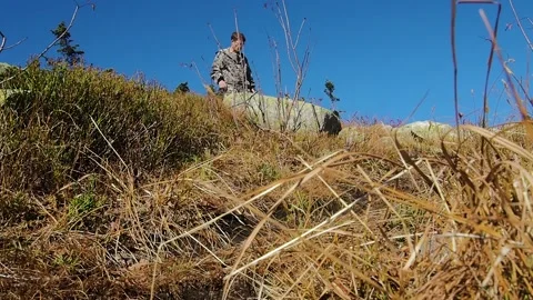 Man tourist down the mountain between the rocks. Stock Footage 96050215