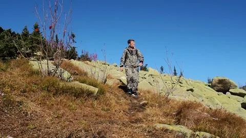 Man tourist down the mountain between the rocks. Stock Footage 96050252