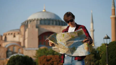 Man tourist looking at map against Ayasofya Mosque, travel concept Stock Footage 201530719