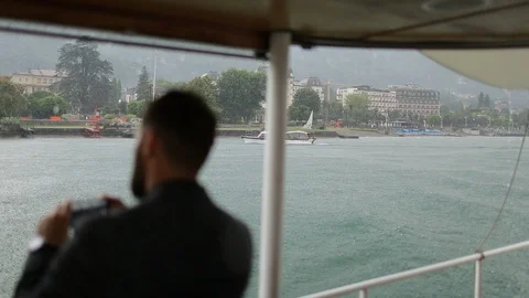 Man Tourist Making Video Of Rainy City. View From The Boat Video stock 123701183