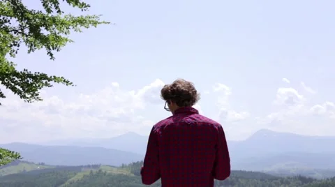 Man tourist in mountain read the map. Man on top of mountain. Tourism concept Stock Footage 68940501