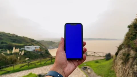 Man tourist with phone, using application mockup on ocean beach background. Life Stock Footage 300490415