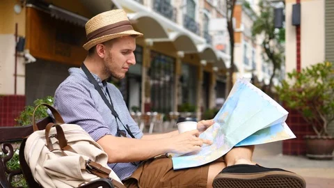 Man Tourist Reading Map And Drinking Coffee. Travel Leisure Activity Concept. Stockbeeldmateriaal 86450715