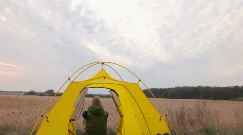  Man Tourist  in tent  watching clouds 4K. Time lapse. RAW output, without birds 스톡 동영상 63392219
