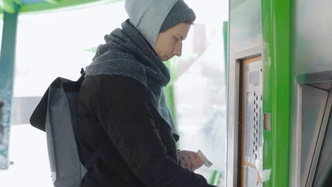 Man tourist tries type touchscreen display to buy a ticket for bus on street Video stock 92118699