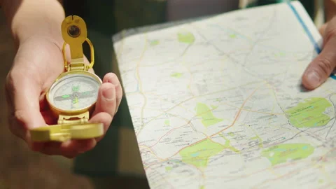 Man tourist using map and compass close-... | Stock Video | Pond5