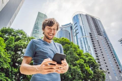 Man Tourist using navigation app on the mobile phone. Navigation map on a Stock Photos
