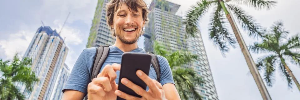Man Tourist using navigation app on the mobile phone. Navigation map on a Stock Photos