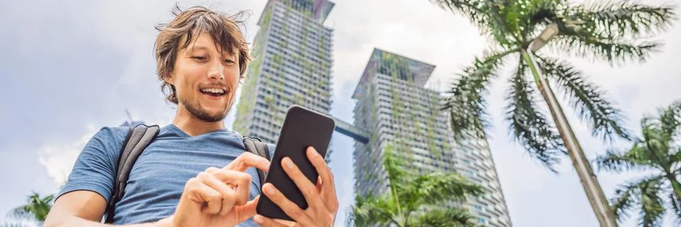 Man Tourist using navigation app on the mobile phone. Navigation map on a Stock Photos