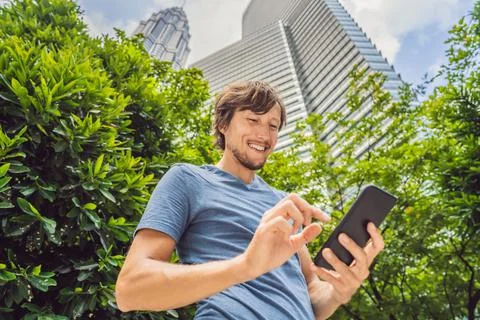 Man Tourist using navigation app on the mobile phone. Navigation map on a Stock Photos