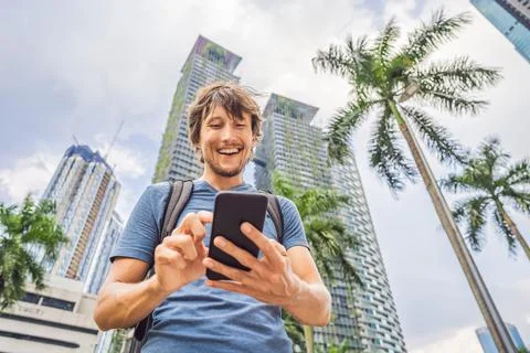 Man Tourist using navigation app on the mobile phone. Navigation map on a Stock Photos