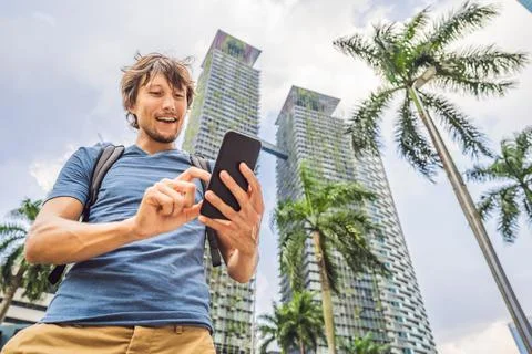 Man Tourist using navigation app on the mobile phone. Navigation map on a Stock Photos